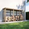 Abri-bûches COLOMBUS XXL en ambiance dans un jardin, contre un mur avec des bûches entreposées à l'intérieur
