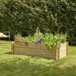 Carré potager BASIL 214L vue de 3/4 en situation dans un jardin avec des plantations dedans