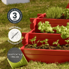 Zoom sur le carré potager ANGELIC 140L peint en rouge, avec des icônes signalant sa garantie, son traitement et son géotextile i