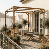 Pergola Solia montée, en situation sur un balcon, abritant une table et deux chaises