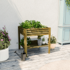 Carré potager surélevé en bois KUB 90L, en situation avec des accessoires de culture autour