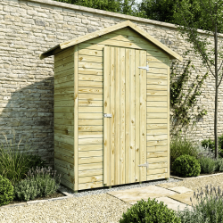 Armoire de jardin LEO en situation dans un jardin, sur la partie terrasse, contre un mur, la porte fermée.